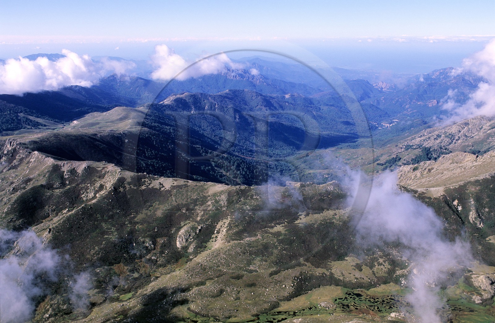 France, Corse du Sud, mountains of Corsica coming out of the clouds (aerial view)
