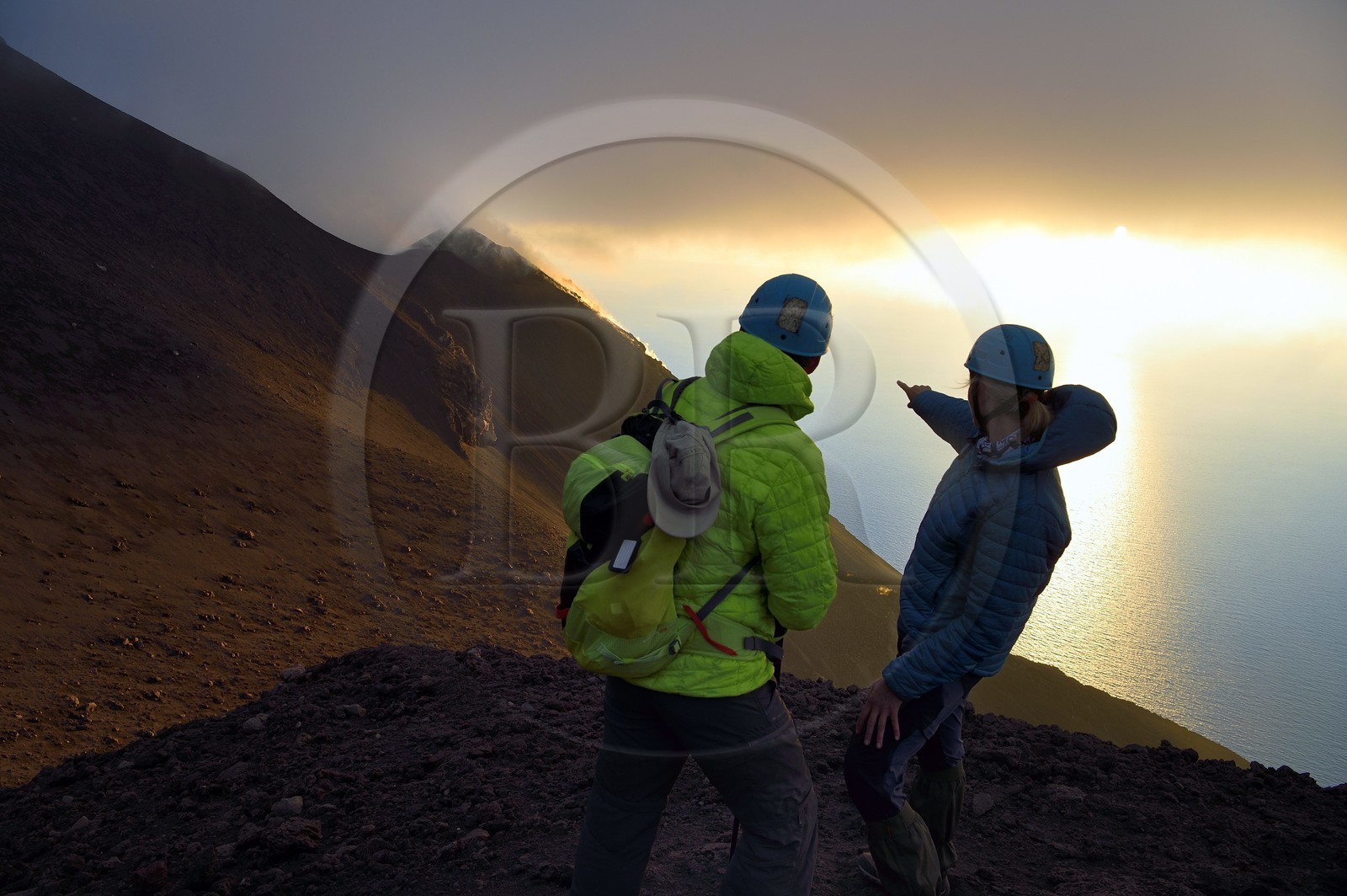 Italy, Sicily, Aeolian Islands, listed as World Heritage by UNESCO, Stromboli island, hikers watching the fumaroles on the slopes of the active volcano at sunset